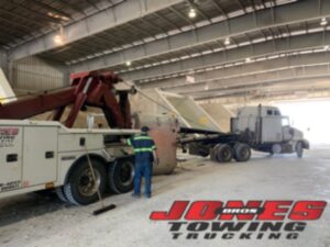 Tile factory calls for heavy towing services as truck falls on its side